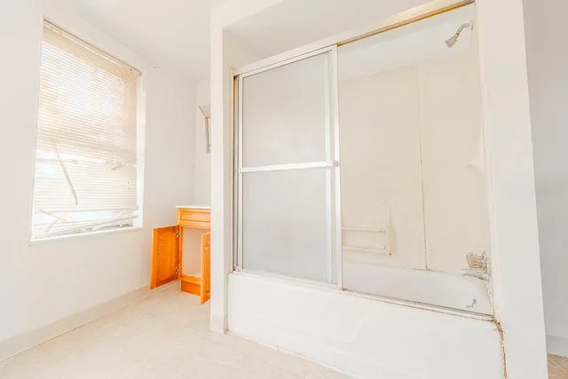 a bathroom with a tub and a window
