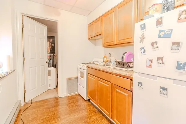 a kitchen with cabinets and wooden floor