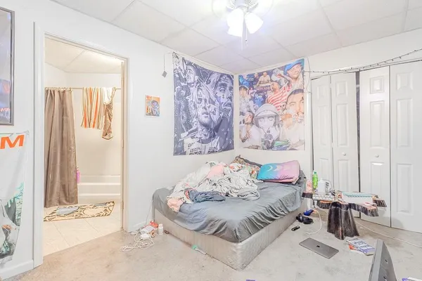 a bedroom with a bed and a painting on the wall