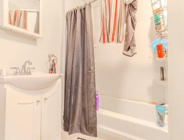 a bathroom with a sink and a shower curtain