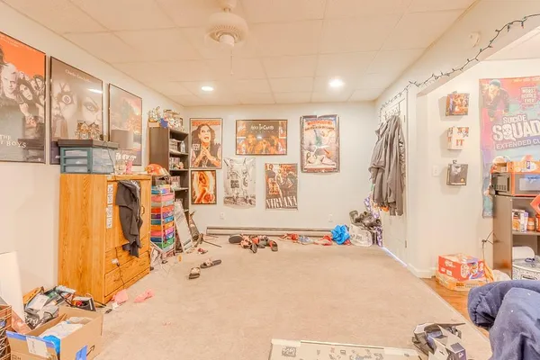 a bedroom with furniture and a large window