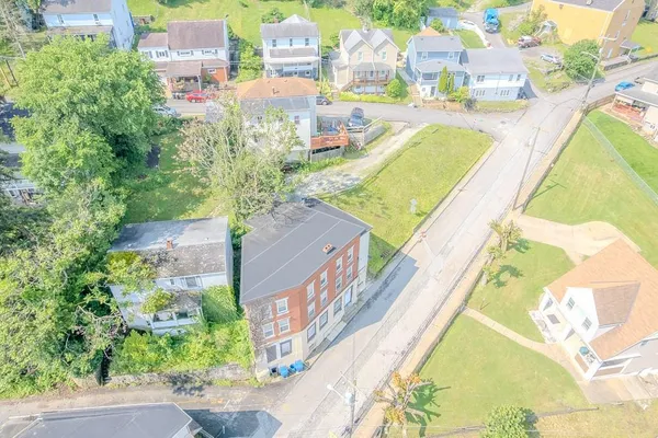 an aerial view of residential houses with outdoor space