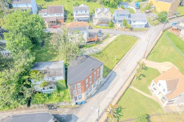 an aerial view of residential houses with outdoor space