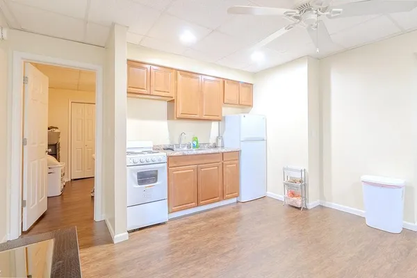 a kitchen with a refrigerator oven stove and a sink