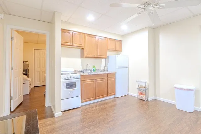a kitchen with a refrigerator oven stove and a sink