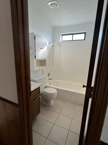 a bathroom with a granite countertop bathtub shower sink and toilet