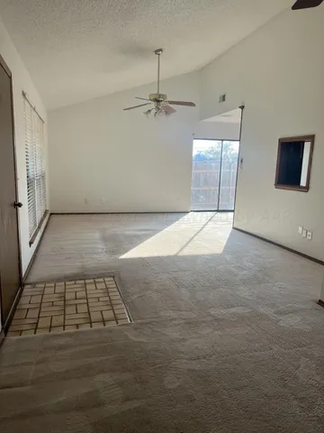 an empty room with windows and cabinet