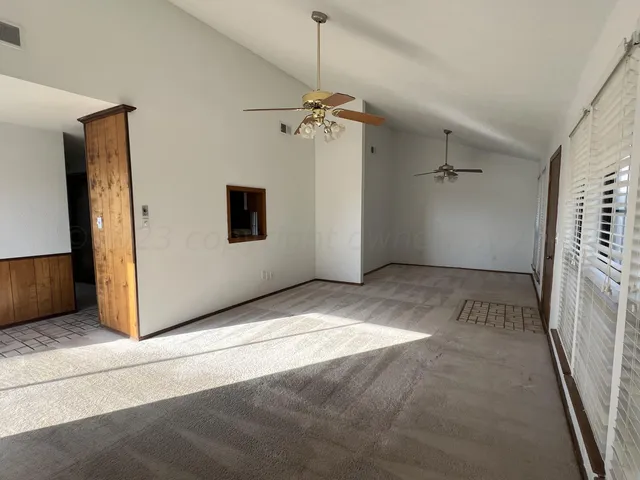 a view of a hallway with a chandelier fan