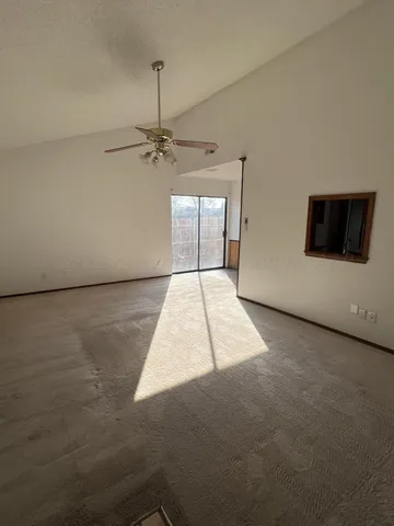 a view of a livingroom with a ceiling fan and window