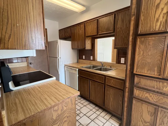 a kitchen with a sink appliances and cabinets