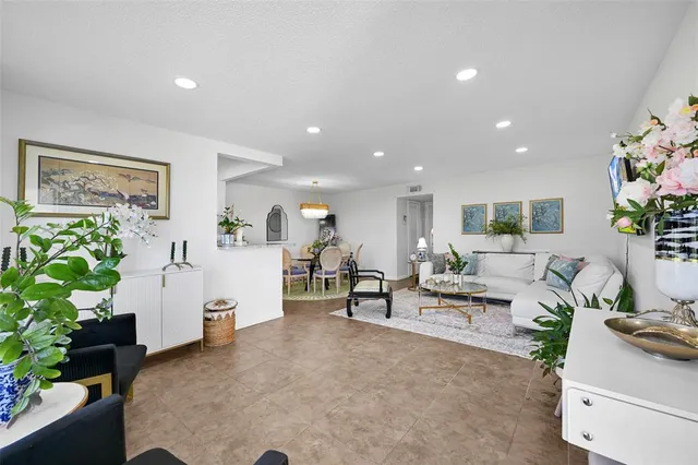 a living room with furniture and a potted plant