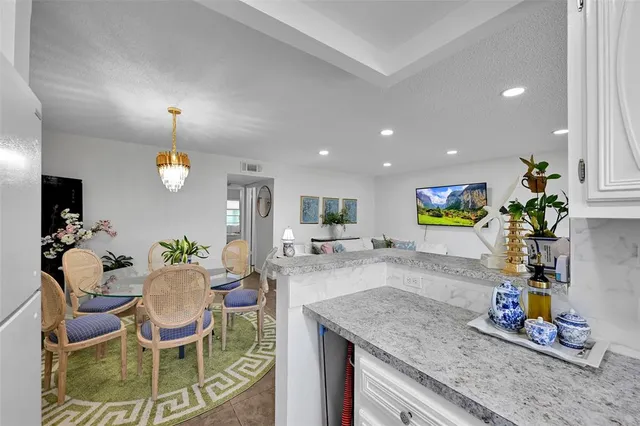 a kitchen with granite countertop dining table and chairs