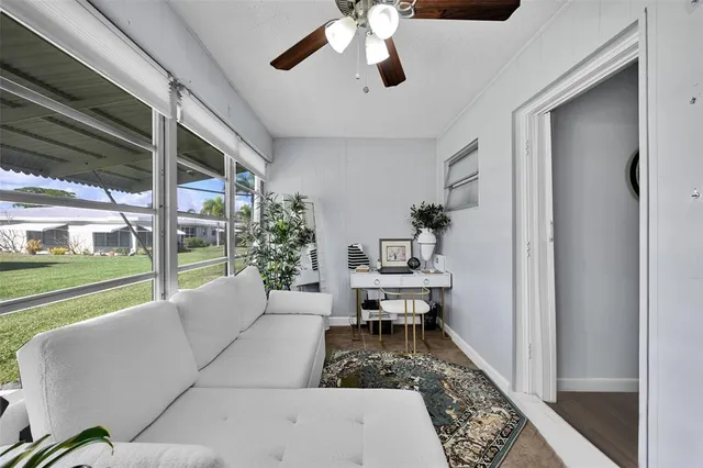 a living room with furniture and a floor to ceiling window