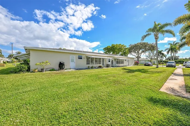 a front view of a house with a big yard