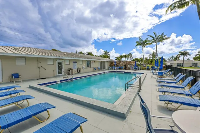 a view of a patio with swimming pool table and chairs