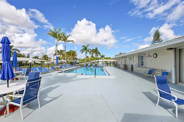 a swimming pool with outdoor seating and city view