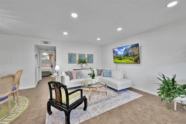 a living room with furniture and a potted plant