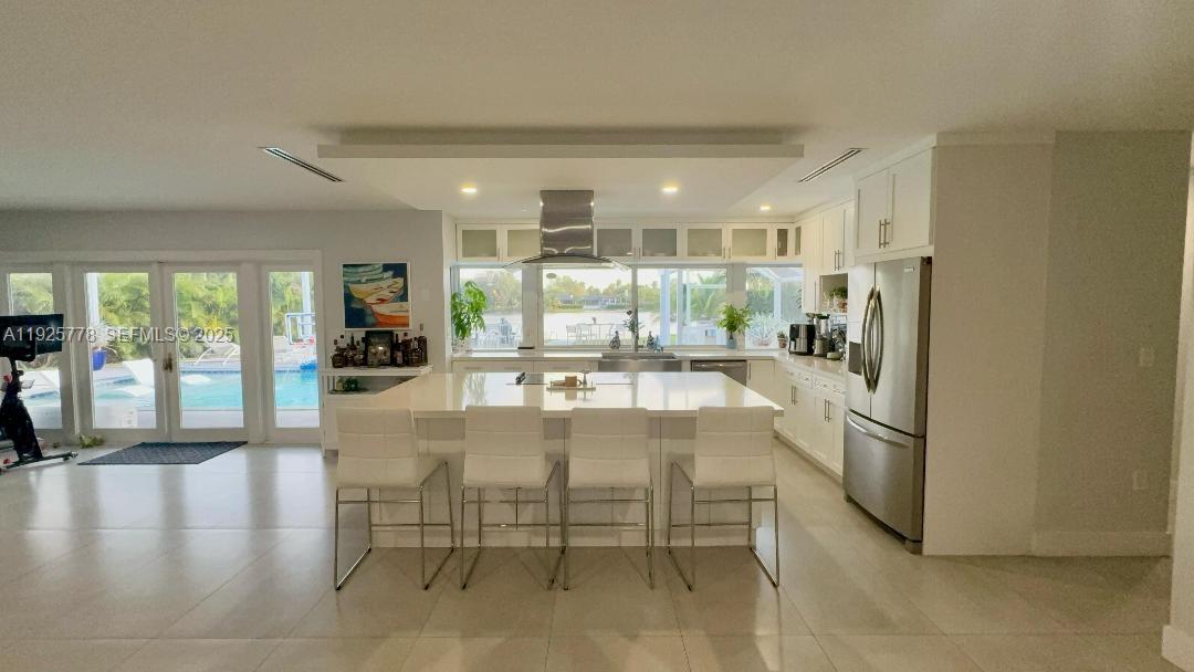 6890 Winged Foot Drive Hialeah, FL 33015 - Photo 5 of 8 a kitchen with stainless steel appliances granite countertop a refrigerator and a stove top oven