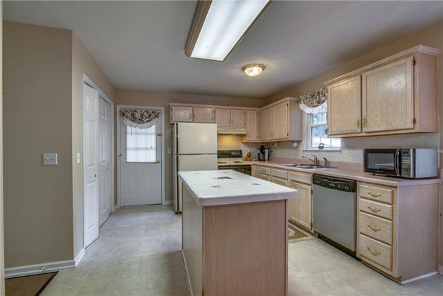 150 Gaskins Road Dickson, TN 37055 - Photo 9 of 20 Blonde Cabinetry w/ Tile Backsplash