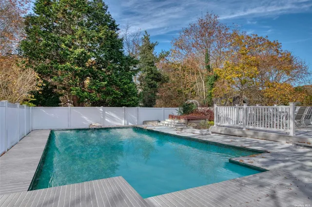 a view of a backyard with swimming pool