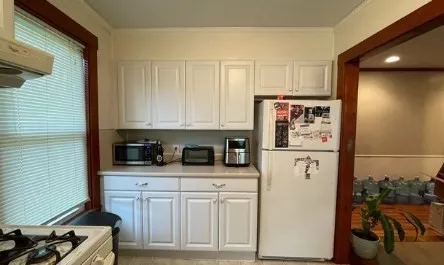 a kitchen with stainless steel appliances white cabinets and a stove top oven