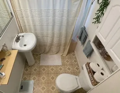 a bathroom with a toilet and a mirror