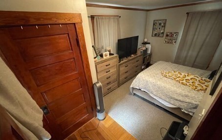471 Gleasondale Road, Unit 1 Stow, MA 01775 - Photo 7 of 11 a bedroom with a bed and a flat tv screen on the dresser