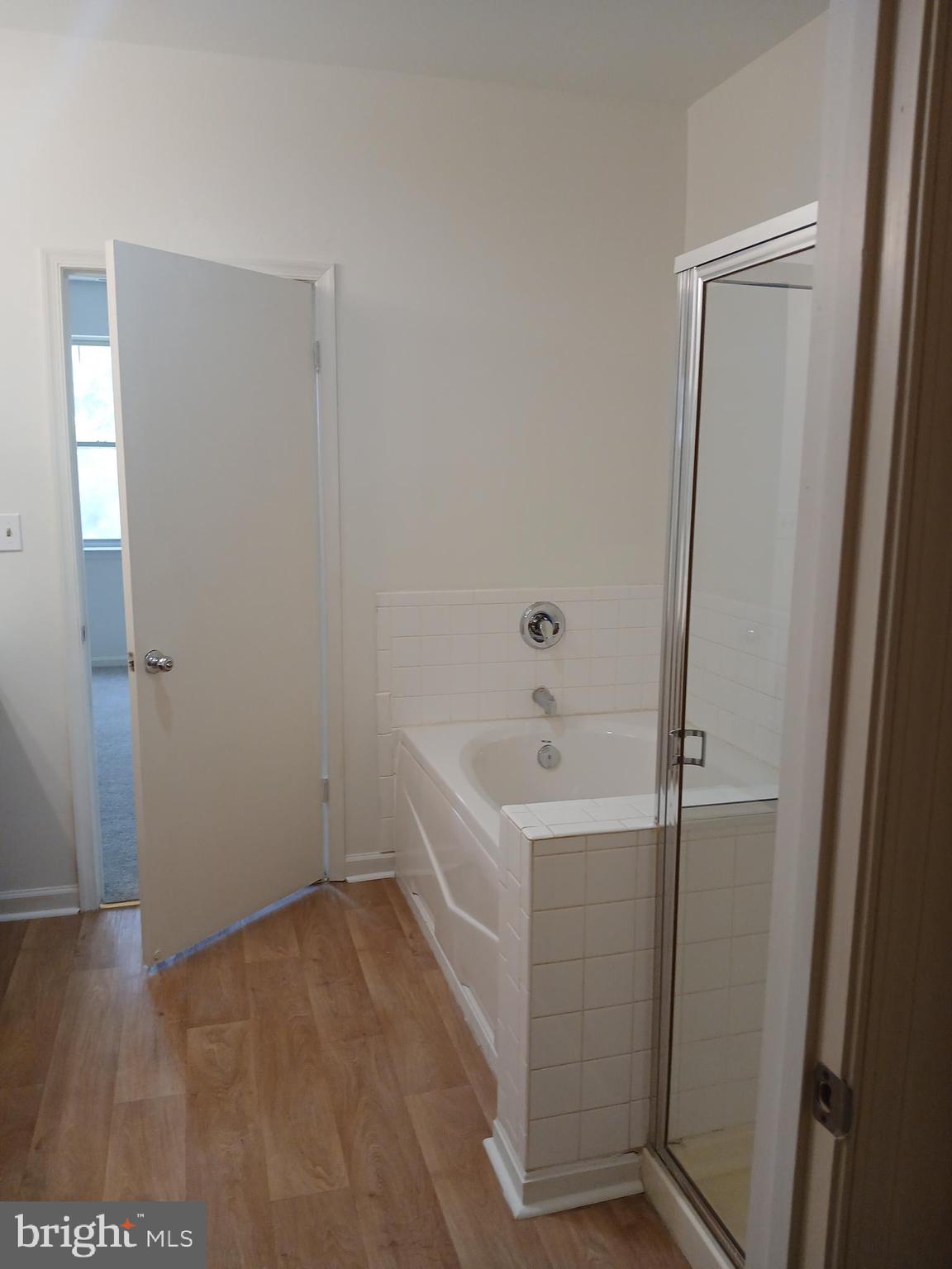 7201 Bogley Road, Unit 203 Windsor Mill, MD 21244 - Photo 17 of 21 a white bath tub sitting in a bathroom