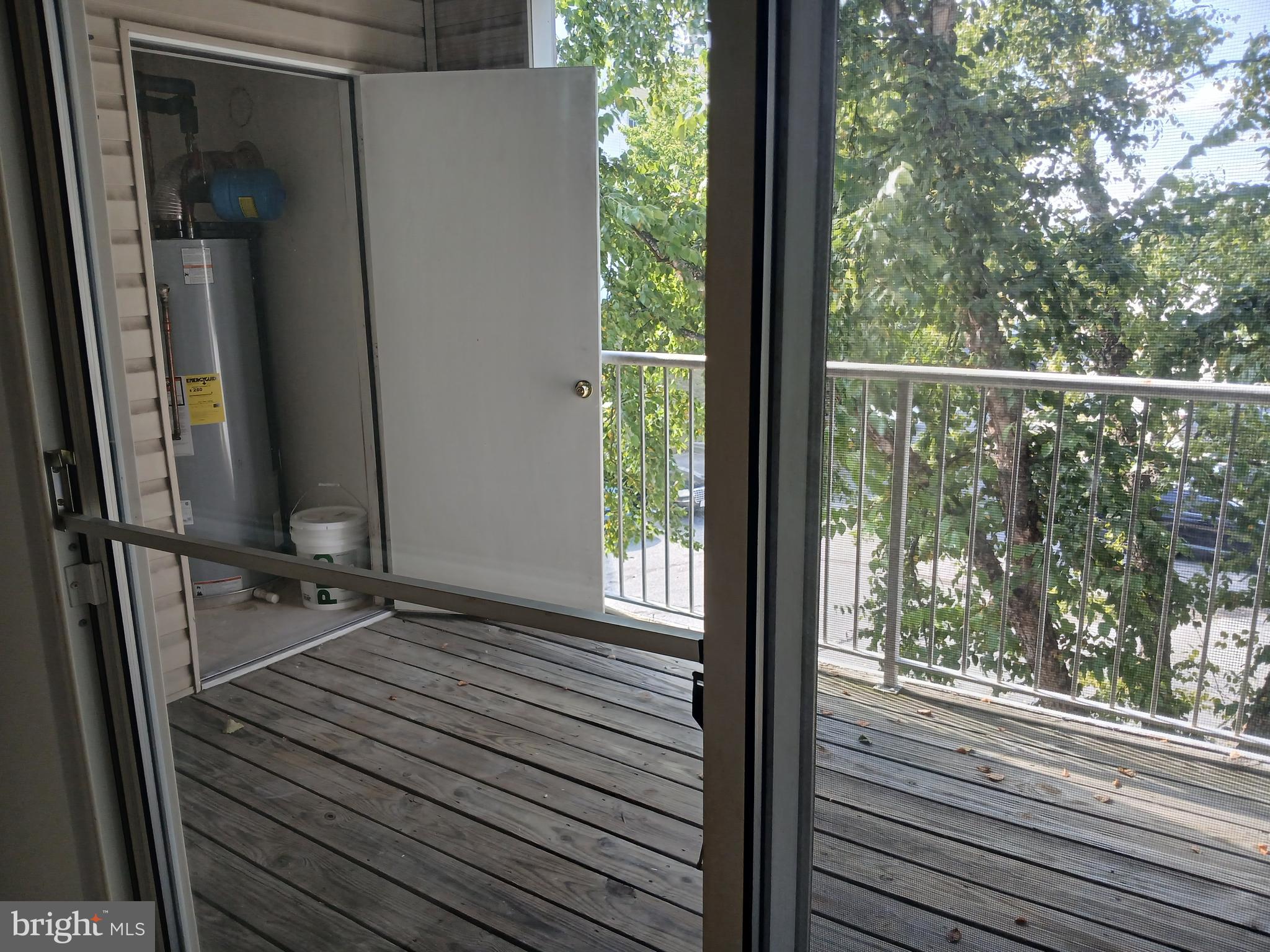 7201 Bogley Road, Unit 203 Windsor Mill, MD 21244 - Photo 5 of 21 a view of a balcony with wooden floor