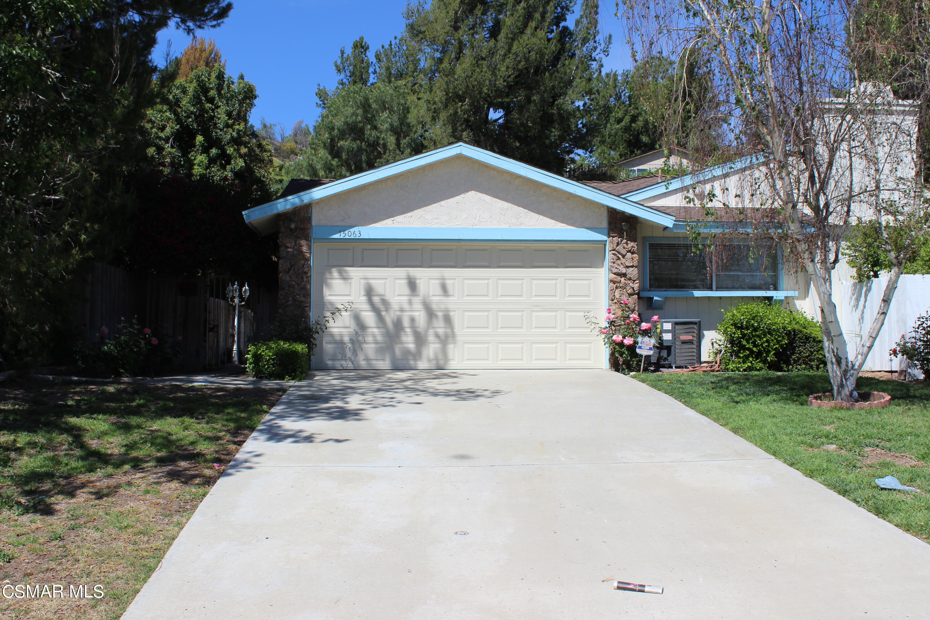 15063 Reedley Street Moorpark, CA 93021 - Photo 1 of 18 a front view of a house with a yard and garage