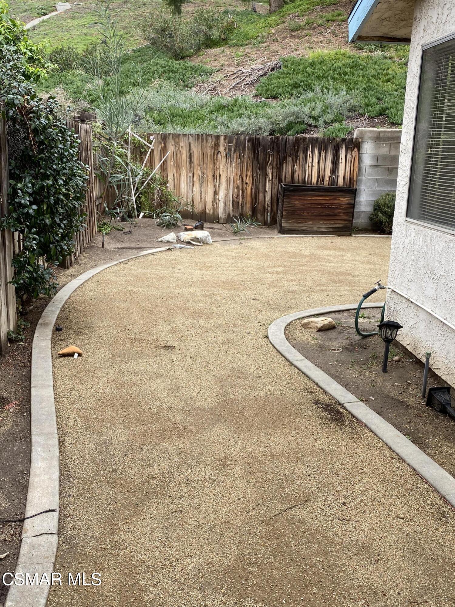15063 Reedley Street Moorpark, CA 93021 - Photo 13 of 18 a backyard of a house with table and chairs wooden floor and fence
