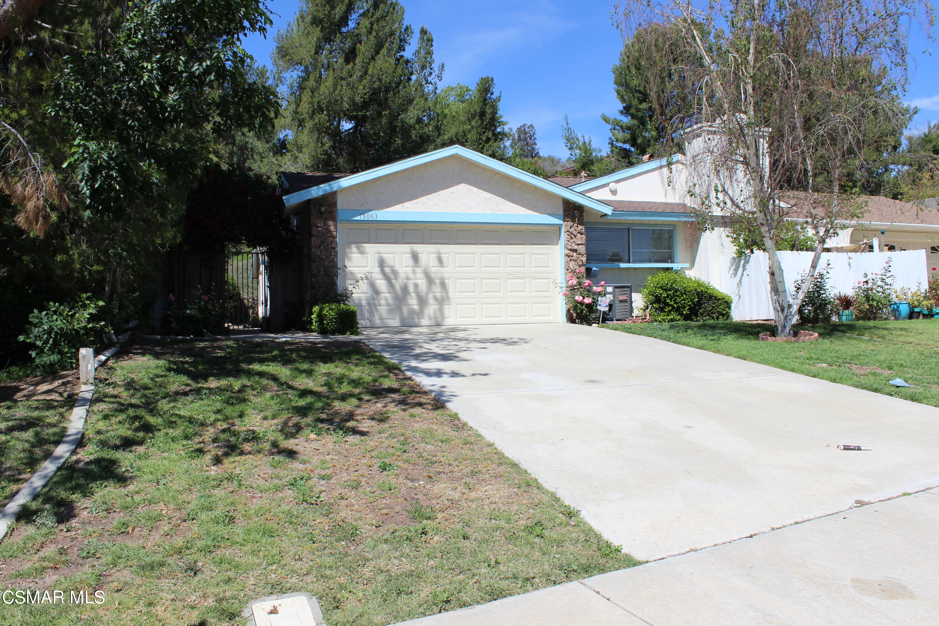 15063 Reedley Street Moorpark, CA 93021 - Photo 18 of 18 a front view of a house with a yard and garage