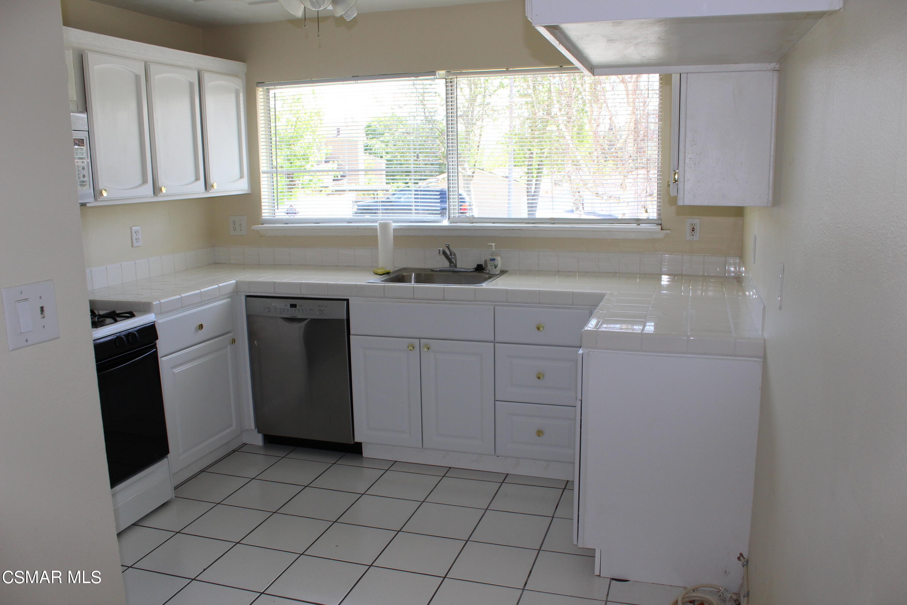 15063 Reedley Street Moorpark, CA 93021 - Photo 2 of 18 a kitchen with a sink window and cabinets