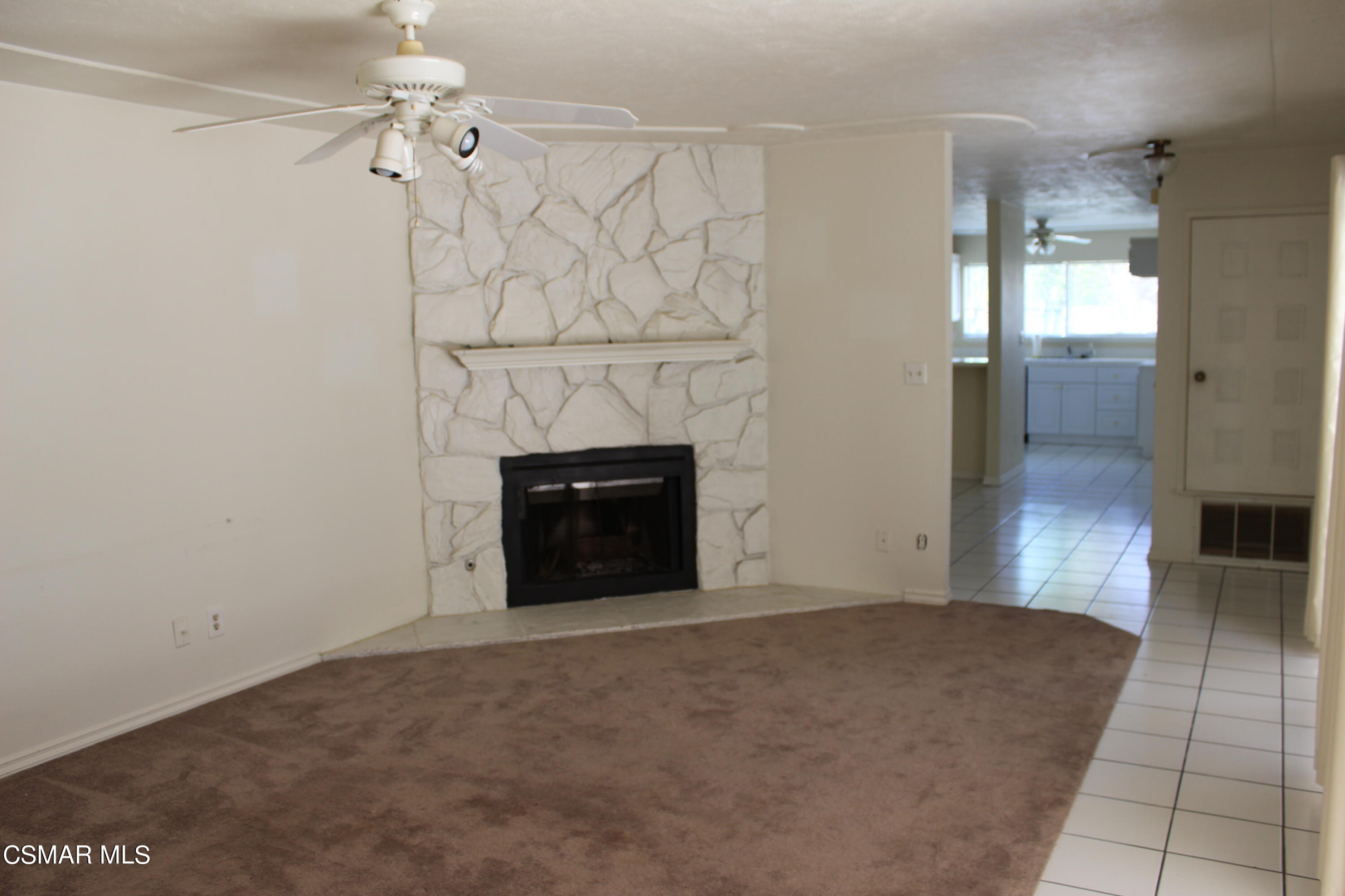 15063 Reedley Street Moorpark, CA 93021 - Photo 8 of 18 wooden floor in an empty room with a fireplace