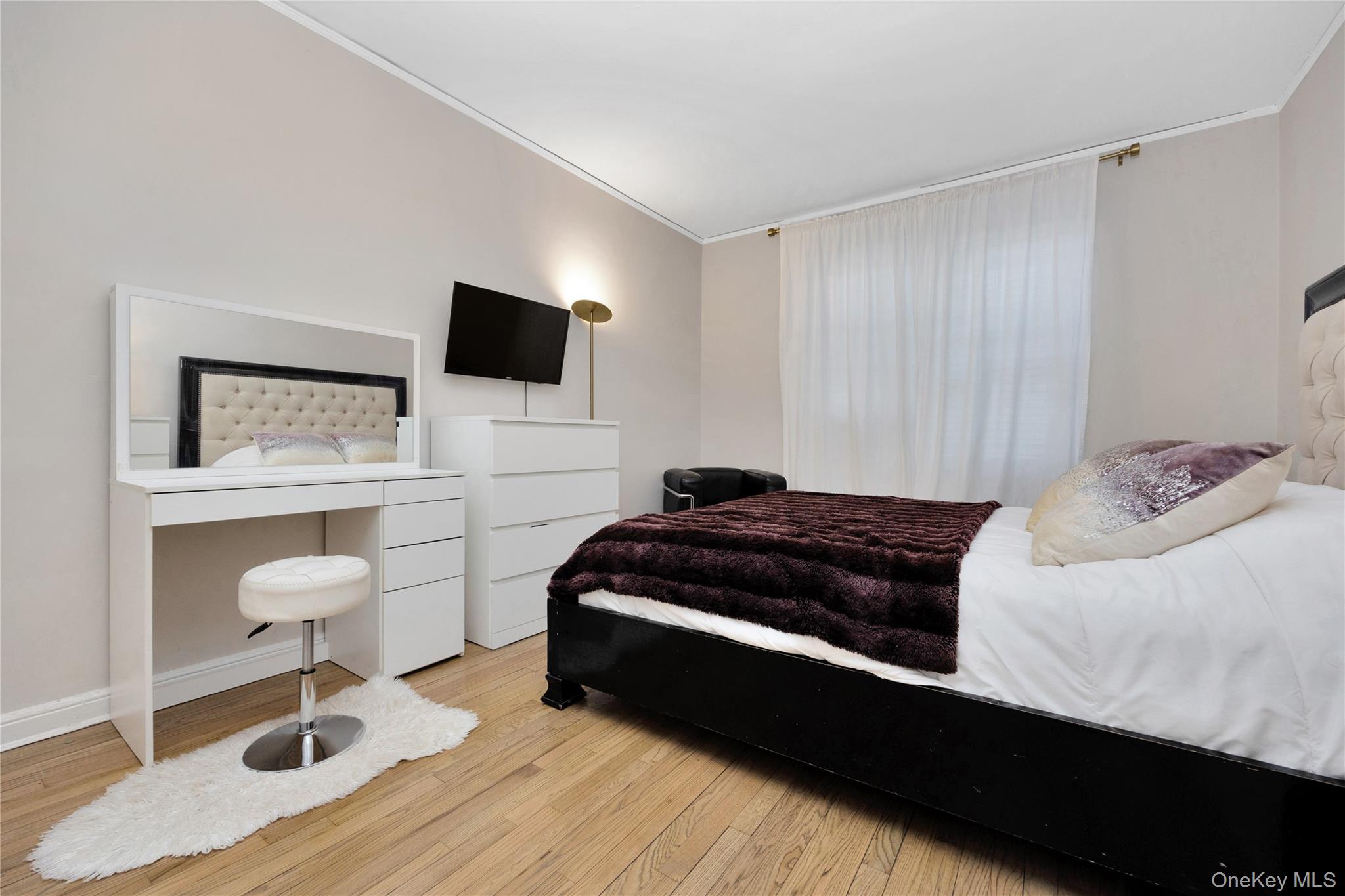 141-42 78th Road, Unit 1D Queens, NY 11367 - Photo 12 of 15 a bedroom with a bed and a television