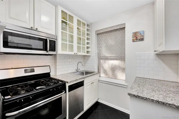 a kitchen with a refrigerator a stove and cabinets