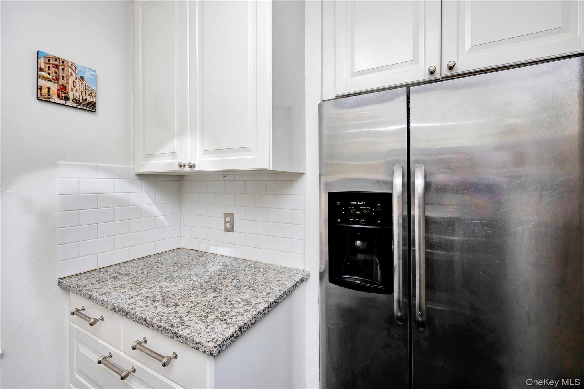 141-42 78th Road, Unit 1D Queens, NY 11367 - Photo 9 of 15 a kitchen with a refrigerator a stove and cabinets