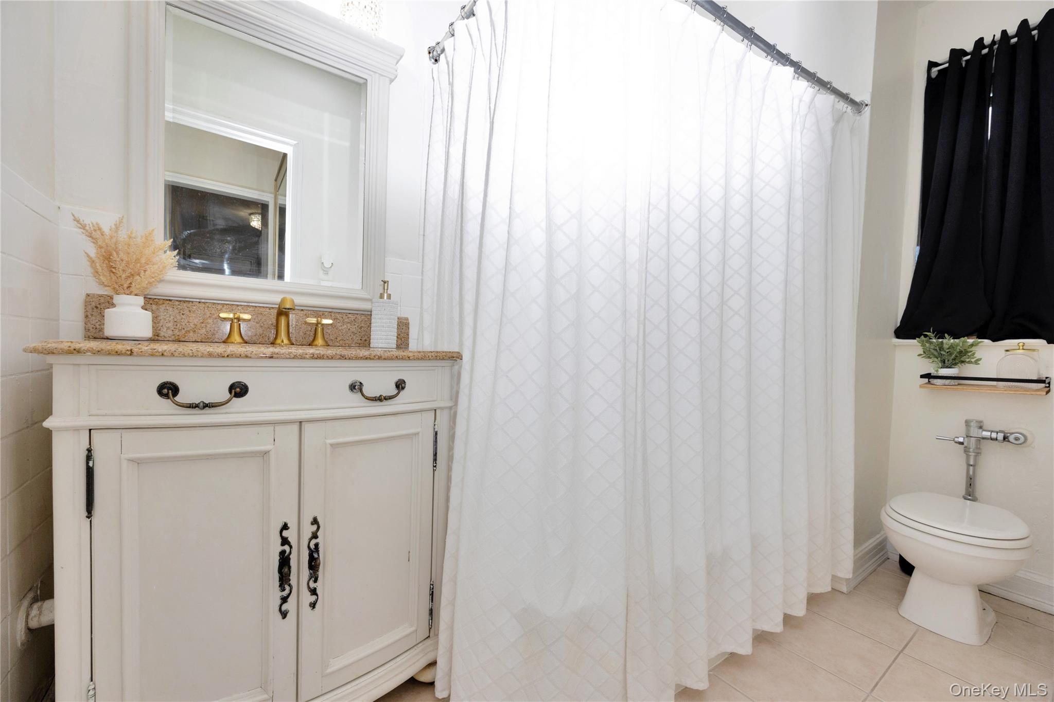 141-42 78th Road, Unit 1D Queens, NY 11367 - Photo 10 of 15 a bathroom with a sink vanity mirror and toilet