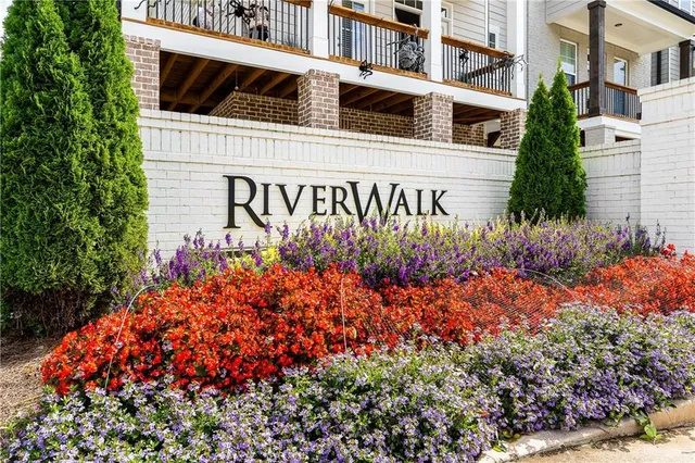 a sign that is in front of flowers