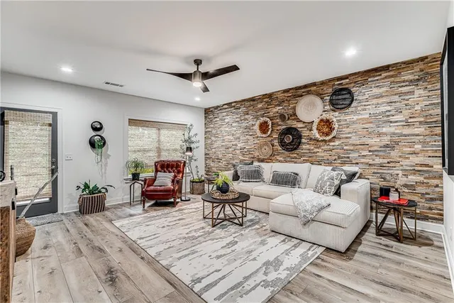 a living room with furniture and wooden floor