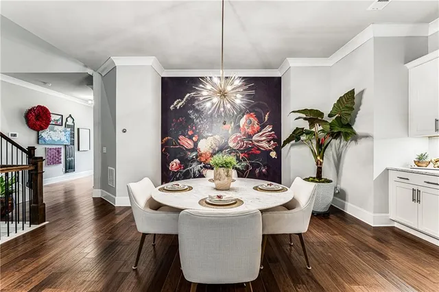 a view of a dining room with furniture wooden floor and chandelier