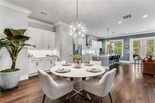 a view of a dining room with furniture and wooden floor