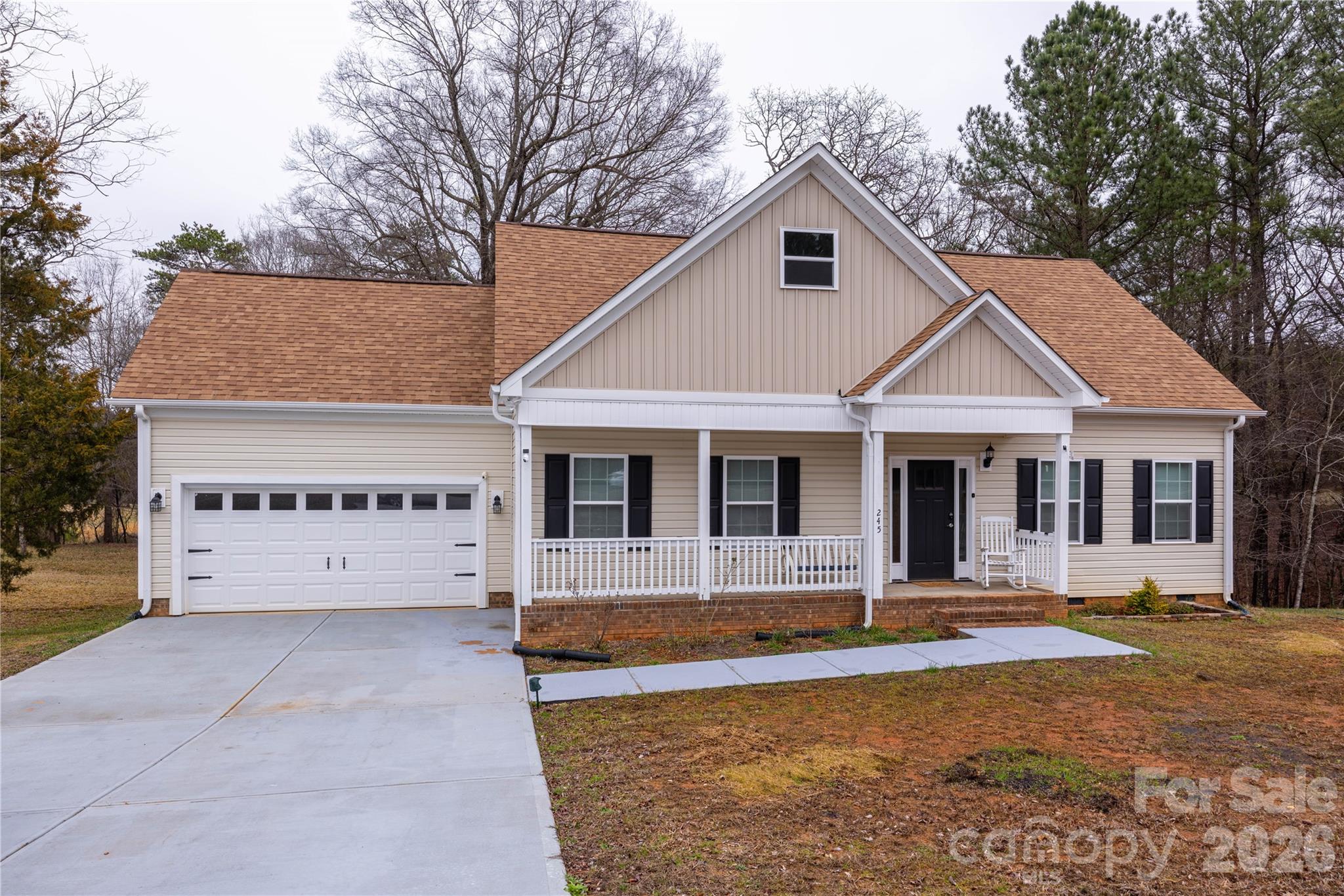 a front view of a house with yard garage and fire pit