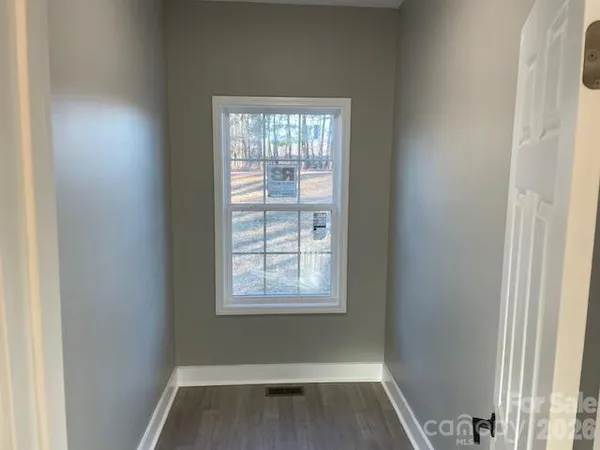 a view of room with window and hardwood floor