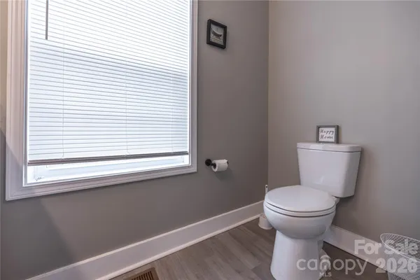 a bathroom with a toilet and a window