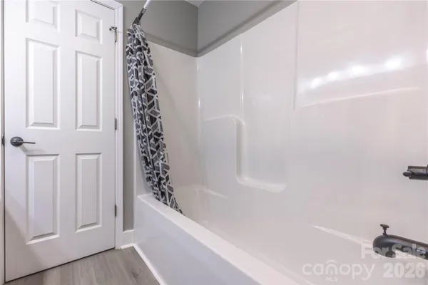 a bathroom with bathtub and shower