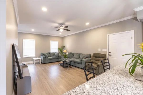 a living room with furniture and a wooden floor