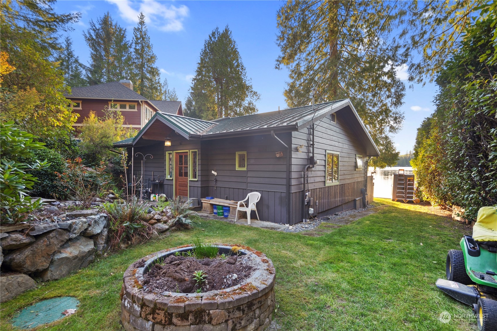 620 South Tulloch Road Snohomish, WA 98290 - Photo 4 of 38 a view of a house with a yard fire pit and a large tree
