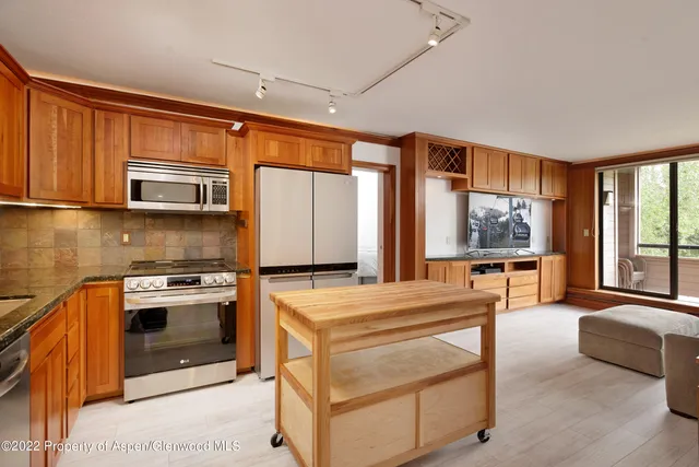 a kitchen with stainless steel appliances a stove sink and microwave