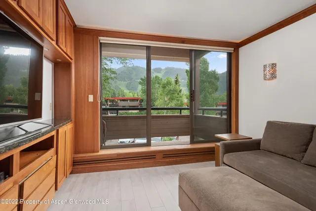 a living room with a large window and a flat screen tv